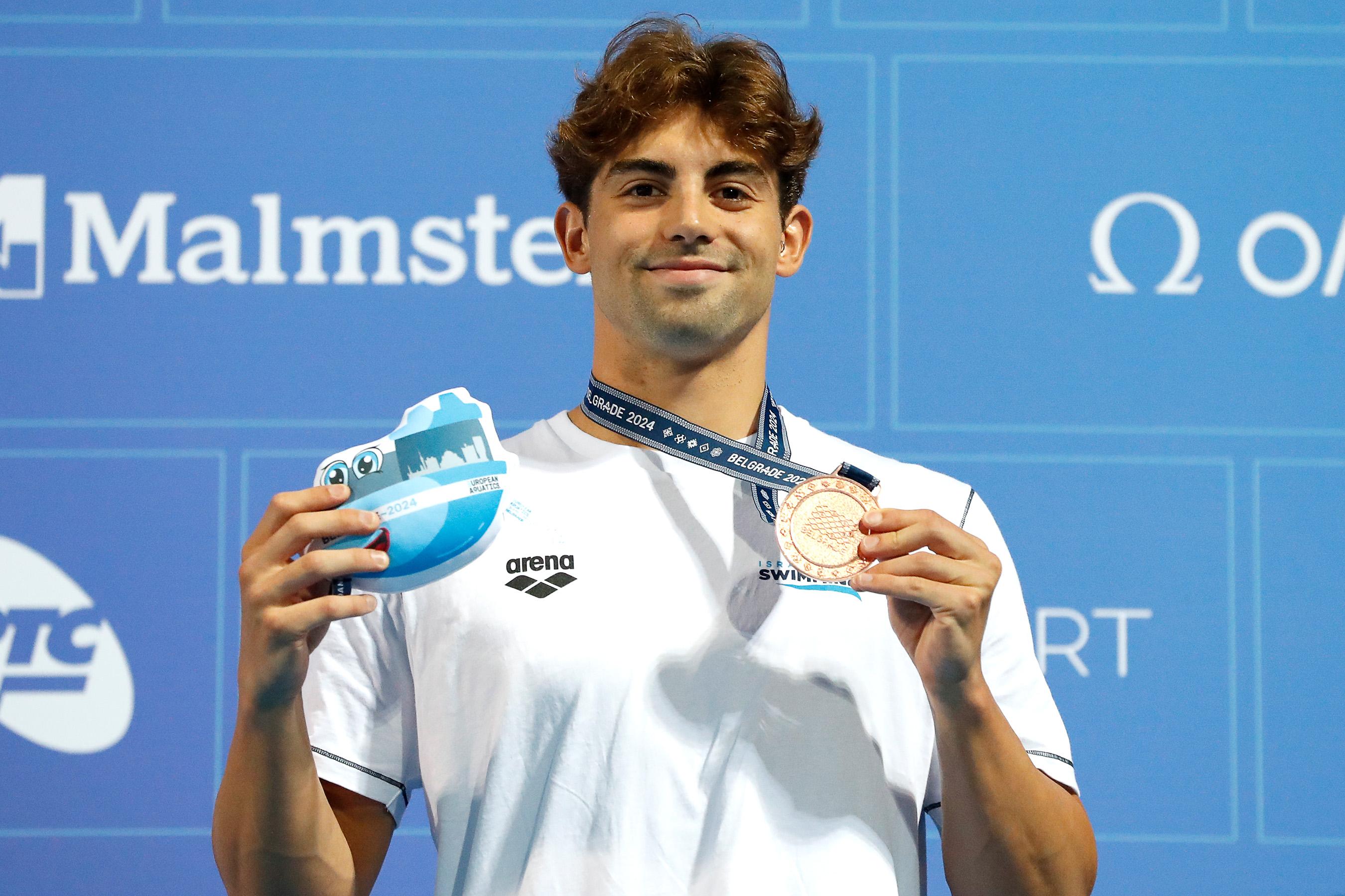 Kristian Pitshugin holding a European Championships medal.